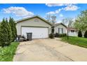 Cozy one-story home with an attached garage, a well-kept lawn, and tasteful landscaping at 3110 S Temple Ave, Indianapolis, IN 46237