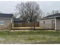 Backyard enclosed by a wood fence and some grass at 3302 S Rybolt Ave, Indianapolis, IN 46221