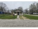 Cozy home with a stone facade, white porch, and gravel driveway; ideal for a starter home at 3302 S Rybolt Ave, Indianapolis, IN 46221
