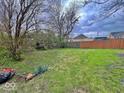 A large backyard with green grass and a wooden fence, offering plenty of outdoor space at 359 W 26Th St, Indianapolis, IN 46208