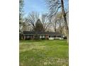 Lovely brick ranch-style home features green shutters, a white porch, and a well-kept lawn at 4290 Manning Rd, Indianapolis, IN 46228