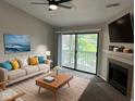 Bright living room with cozy fireplace and sliding doors to a private balcony at 4311 Village Parkway W Cir # 6, Indianapolis, IN 46254