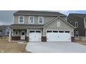 Charming two-story home featuring a spacious two-car garage, neutral siding, and a welcoming front porch at 4390 Risen Star Way, Bargersville, IN 46106