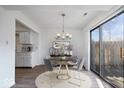 Cozy dining room featuring a round table, stylish chairs, and a sliding glass door to the outdoors at 456 E Arch St, Indianapolis, IN 46202