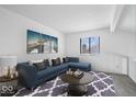 Comfortable living room with a blue sectional sofa, decorative rug, and a bright window at 456 E Arch St, Indianapolis, IN 46202