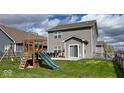 The backyard features a playset, dining table, and sliding glass door offering a great space to relax at 530 Farnham Dr, Westfield, IN 46074