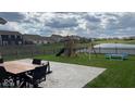Spacious backyard featuring a playset, patio and lush lawn perfect for outdoor activities and entertaining at 530 Farnham Dr, Westfield, IN 46074