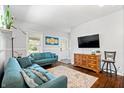 Bright living room with plush blue sofas, hardwood floors, and ample natural light at 5817 Beechwood Ave, Indianapolis, IN 46219