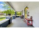 Inviting covered front porch with stylish seating, offering a perfect spot for relaxation at 5817 Beechwood Ave, Indianapolis, IN 46219