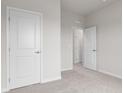 Neutral bedroom featuring carpet, white walls, white trim, and multiple doors at 5964 Lomita Ave, Plainfield, IN 46168