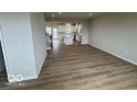 Open-concept living space showcasing beautiful hardwood floors and abundant natural light at 5964 Lomita Ave, Plainfield, IN 46168