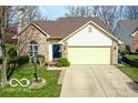 Well-kept home featuring a lush front lawn and a driveway leading to a two-car garage at 701 Danver Ln, Beech Grove, IN 46107