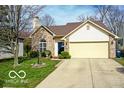 Attractive home with a manicured lawn and a driveway leading to a two-car garage at 701 Danver Ln, Beech Grove, IN 46107