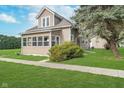 Attractive home exterior featuring a well-kept lawn, established trees, and sidewalk at 702 S Fanning St, Sheridan, IN 46069