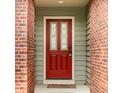 Inviting front door with decorative glass panels, surrounded by brick columns and neutral siding at 7023 Steinmeier W Dr, Indianapolis, IN 46220
