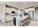 Modern kitchen features a center island with seating, stainless appliances, and bright, white cabinetry at 7313 Deerberg Dr, Indianapolis, IN 46259
