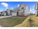 Suburban home showing a manicured lawn and inviting architecture, blending modern design with neighborhood charm at 8673 Laurelton Pl, Brownsburg, IN 46112