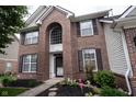 Close-up view of a brick home showcasing an arched window above the front door and well-maintained landscaping at 8748 N Autumnview Dr, McCordsville, IN 46055