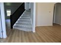 Entryway with a staircase, modern railings, and wood floors leading to the main living area at 9207 Foudray N Cir, Avon, IN 46123