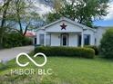 Inviting single-story home with a cozy porch and well-maintained landscaping, enhancing its charming appeal at 1 Lenora Ave, Indianapolis, IN 46231