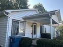 Cozy front porch with covered entrance, complemented by well-maintained landscaping and a blue recycling bin at 1 Lenora Ave, Indianapolis, IN 46231