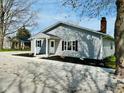 Charming one-story home with gray siding, black shutters, and a well-manicured front yard at 103 N Nebraska St, North Salem, IN 46165