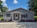 Well-maintained home features a covered entryway, updated landscaping, and charming curb appeal at 103 N Nebraska St, North Salem, IN 46165