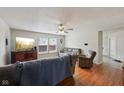 Cozy living room with hardwood floors, ceiling fan, and comfortable seating at 10881 August Dr, Ingalls, IN 46048