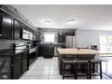 Modern kitchen featuring stainless steel appliances, a large island, and ample cabinet space at 1123 Barley Cir, Carmel, IN 46032