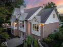 Rear exterior of brick home featuring large windows, a walkout basement, and an elevated deck at 12304 Ridgeside Rd, Indianapolis, IN 46256