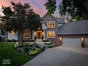 Beautiful brick home with manicured landscaping and a spacious driveway leading to a three-car garage at 12304 Ridgeside Rd, Indianapolis, IN 46256