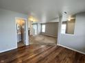 Spacious open-concept living room featuring hardwood floors and a glimpse of the bathroom at 12657 Republic Dr, Fishers, IN 46037