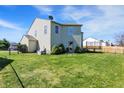 View of backyard with full lawn, fenced in, and featuring a trampoline at 1330 Redwood Dr, Greenfield, IN 46140