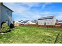 Large, grassy backyard with chain-link fence, perfect for outdoor activities and pets at 1330 Redwood Dr, Greenfield, IN 46140