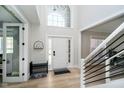 Bright foyer featuring a high ceiling, large windows, and modern staircase at 13933 Wildcat Dr, Carmel, IN 46033