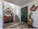 Inviting foyer featuring wood flooring, a staircase, and decorative accents enhancing the entryway's appeal at 13971 Bruddy Dr, Fishers, IN 46038