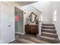 Bright foyer showcasing wood-look flooring, stairway, and stylish decor elements creating a welcoming atmosphere at 13971 Bruddy Dr, Fishers, IN 46038