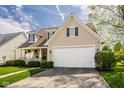 Charming two-story home featuring a covered porch, manicured lawn, and a two-car garage at 15037 Rutherford Dr, Westfield, IN 46074