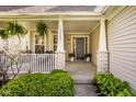 Inviting front porch featuring brick columns, neutral siding, and hanging ferns, perfect for relaxing at 15037 Rutherford Dr, Westfield, IN 46074