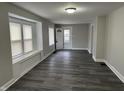 Bright living room featuring modern flooring, a bay window, and a freshly painted interior at 1517 N Gladstone Ave, Indianapolis, IN 46201