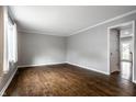 Bright, freshly painted living room with hardwood floors and ample natural light through a large front window at 156 Aspen Way, Carmel, IN 46032