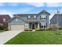 Charming two-story home with a well-maintained lawn, complemented by mature shrubs and a spacious two-car garage at 15723 Myland Dr, Noblesville, IN 46062