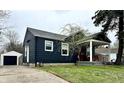 Inviting home exterior featuring a well-kept lawn and a detached garage at 1624 N Whittier Pl, Indianapolis, IN 46218