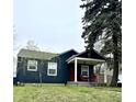 A cozy home with a welcoming front porch and a vibrant red door at 1624 N Whittier Pl, Indianapolis, IN 46218