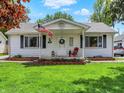 Charming single-story home with a well-maintained lawn and inviting front porch area with an American flag at 1629 N K St, Elwood, IN 46036