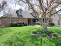Beautifully landscaped front yard with lush green grass and a mature flowering tree at 1737 Friendship Dr, Indianapolis, IN 46217