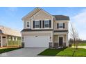 Charming two-story home featuring neutral siding, black shutters, and an attached two-car garage at 2252 Marjorie Way, Shelbyville, IN 46176
