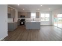 Open concept kitchen with a kitchen island, grey cabinets, and stainless steel appliances at 2252 Marjorie Way, Shelbyville, IN 46176