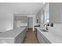 Bright kitchen with stainless steel appliances, quartz countertops, and a central island at 2252 Marjorie Way, Shelbyville, IN 46176