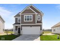 Charming two-story home featuring a two-car garage, neat landscaping, and a classic design at 2268 Marjorie Way, Shelbyville, IN 46176